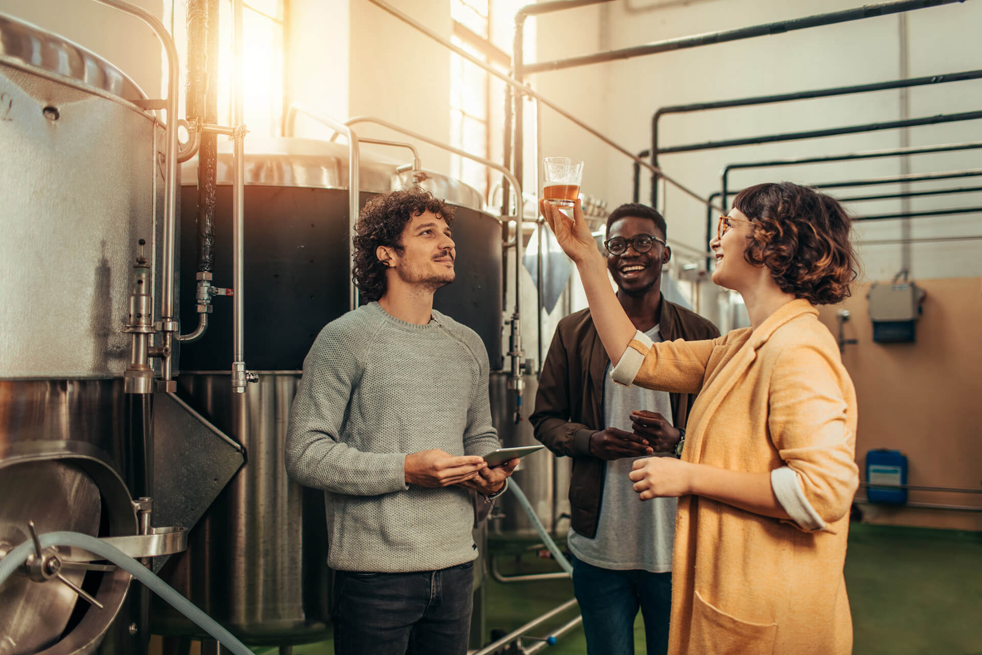 Brew master testing beer in brewery.