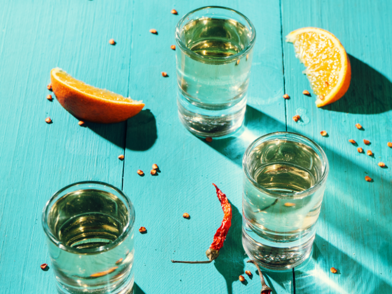 Tequila shots and orange wedges