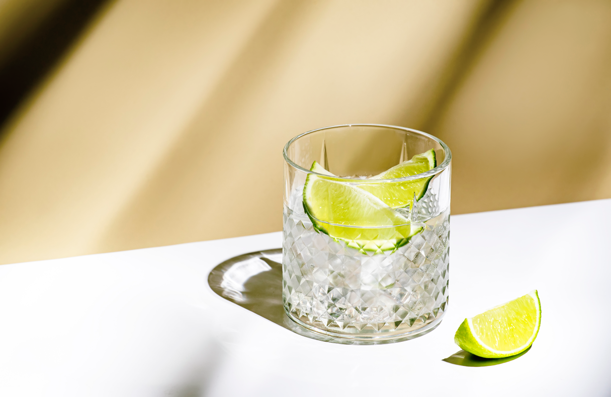 Glass with refreshing beverage and lime